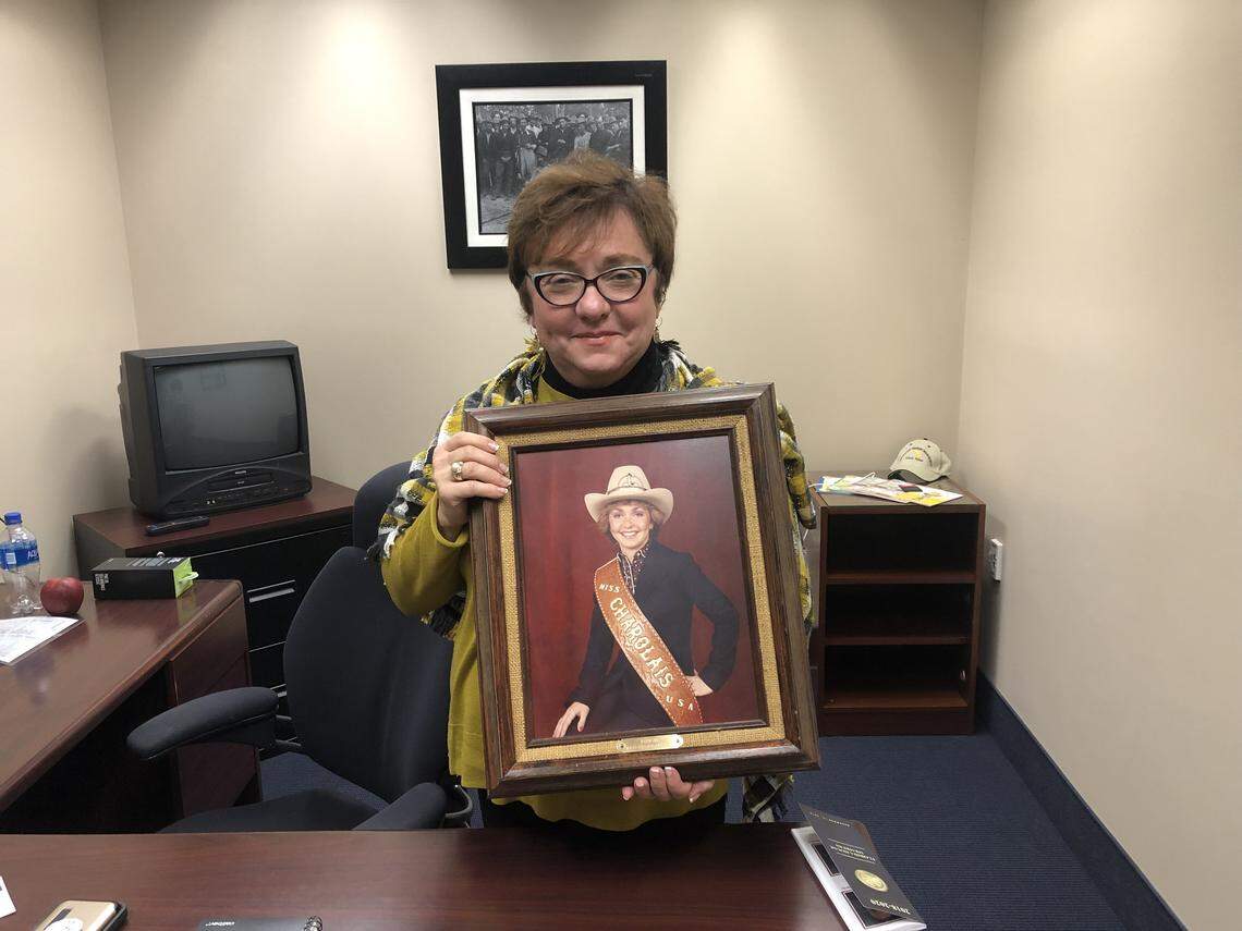 Cannabis Director Holly Bell, with a photo of herself from when she won the “Miss Charolais” competition. Bell won the title at 22 years old for showing Charolais, a breed of cattle.