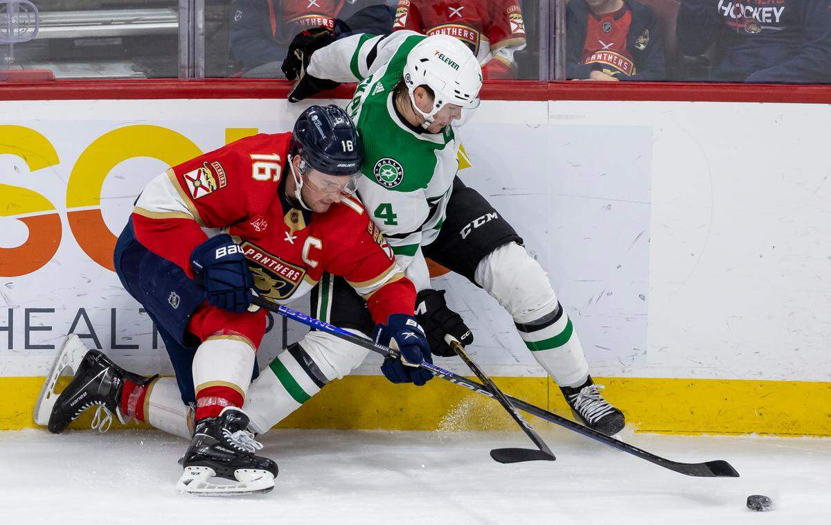 Florida Panthers center Aleksander Barkov (16) and Dallas Stars defenseman Miro Heiskanen (4) compete for the puck in the third period of their NHL game at the Amerant Bank Arena on Wednesday, Dec. 6, 2023, in Sunrise, Fla.
