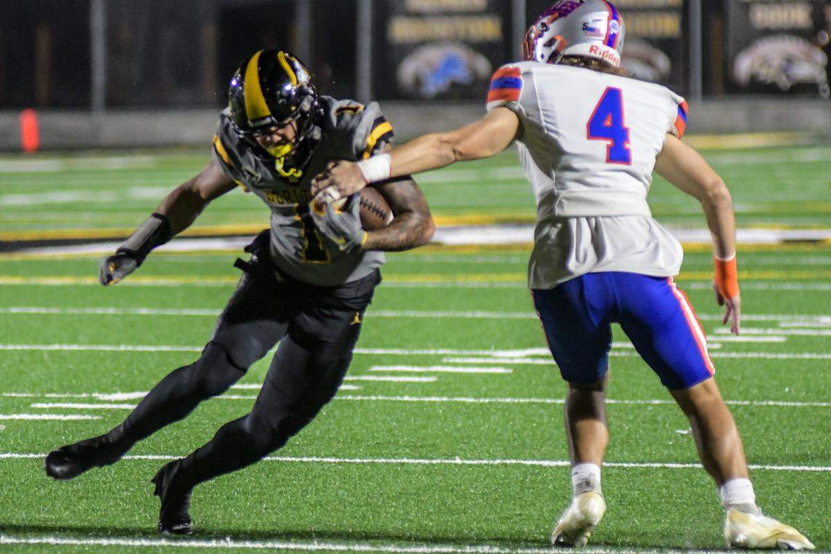 Plantation American Heritage wide receiver Brandon Innis breaks a tackle during a Class 2M state semifinal game against Jacksonville Bolles on Friday, Dec. 2, 2022, at American Heritage School in Plantation, Florida.