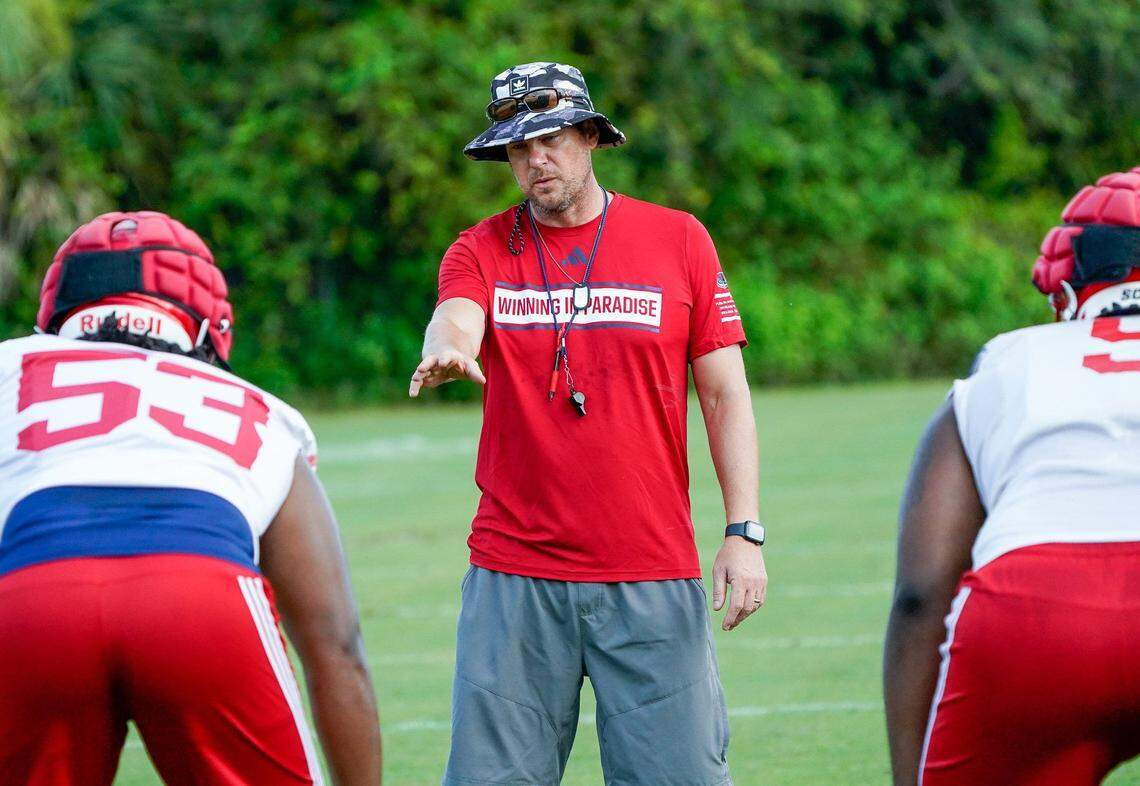 Florida Atlantic head coach Tom Herman works with the defense during practice at the Schmidt Family Complex in Boca Raton.