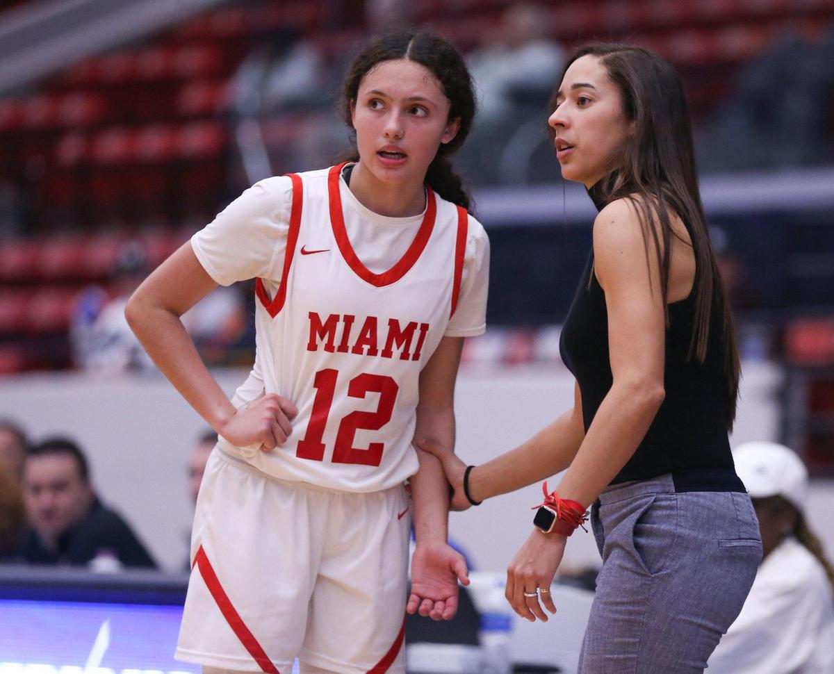 Miami Christian School coach Chanel Davila talks with guard Ziul Gonzalez (12) during the game against St John Neumann High during a girls basketball Class 2A state semifinal in Lakeland on Wednesday, February 23, 2022.