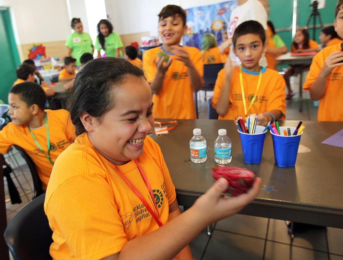 Alexandra Badir-12 years old, giggles as she smells a Dragon Fruit at the Diabetes Camp sponsored by Nicklaus Children's Hospital where kids stay for a weeklong overnight camp for children with diabetes and supervised by nurses and care teams on Monday, July 9, 2018
