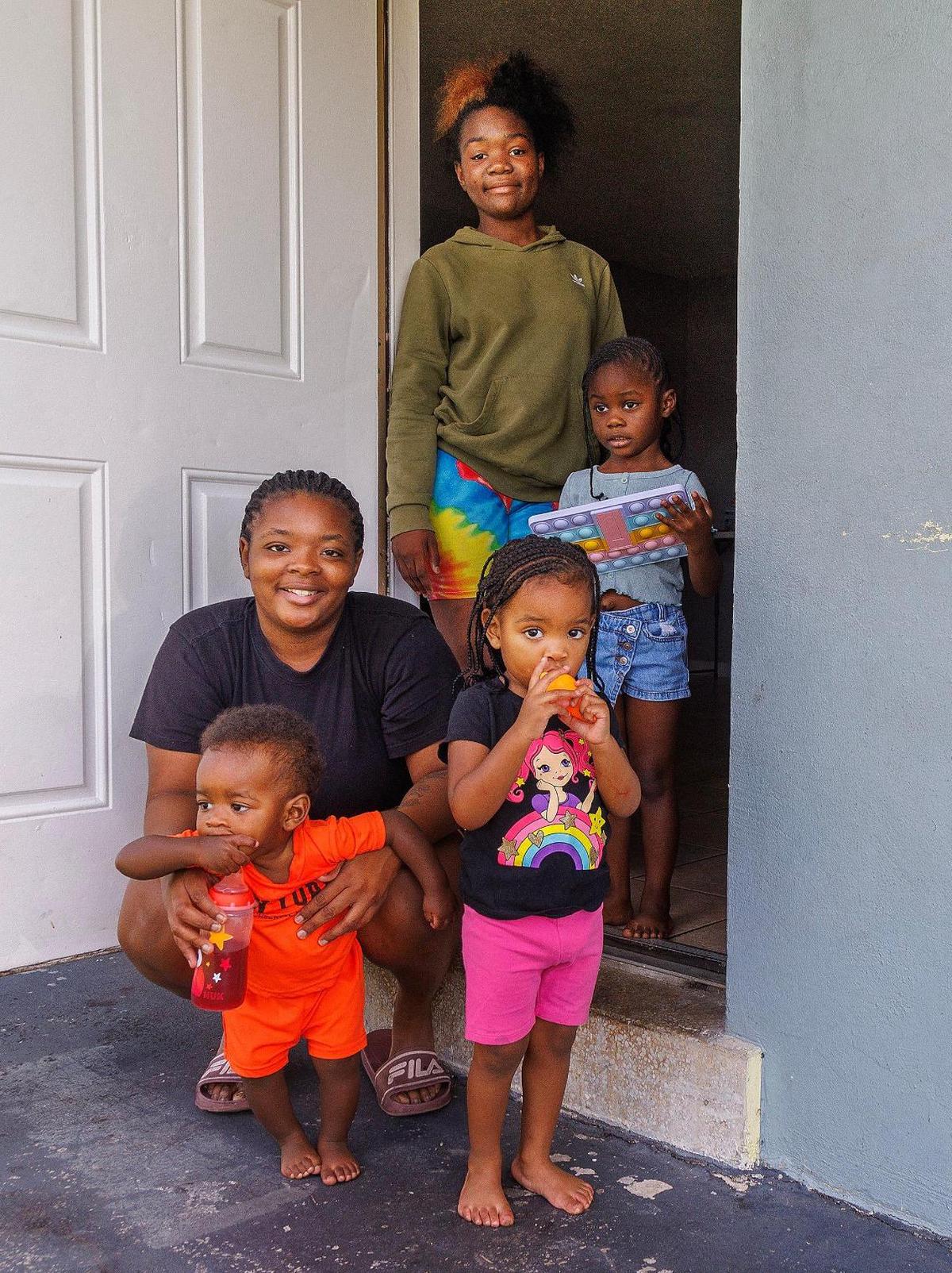 Charisma Robbins (standing up) lives with her sister Brenecha Robbins and her children from left: Jermal Cornwall, 1;  Raniyah Cornwall, 2;  and Amira Johnson, 4, in their apartment in Fort Lauderdale.