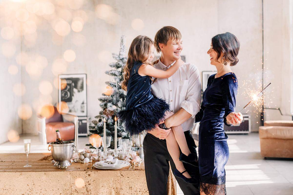 mother father celebrating new year's eve with daughter