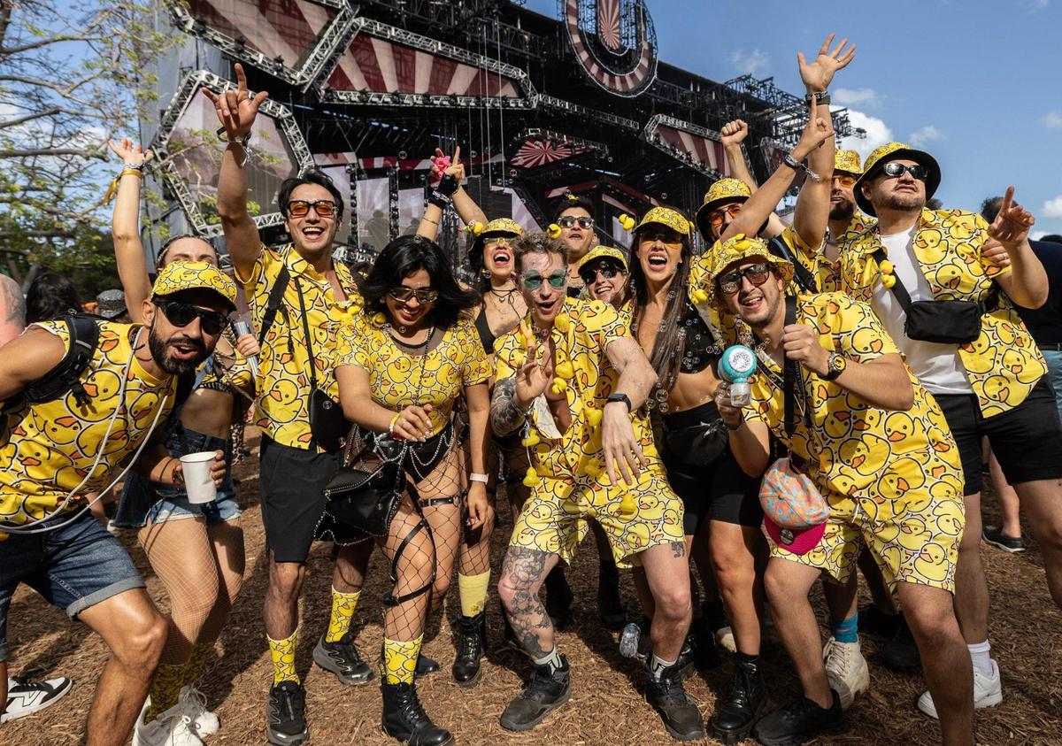 A gathering of friends from Mexico, who named themselves “Los Patos Locos,” gather during Ultra Music Festival’s 25th anniversary at Bayfront Park, in Miami, Florida, on Friday, March 28, 2025.