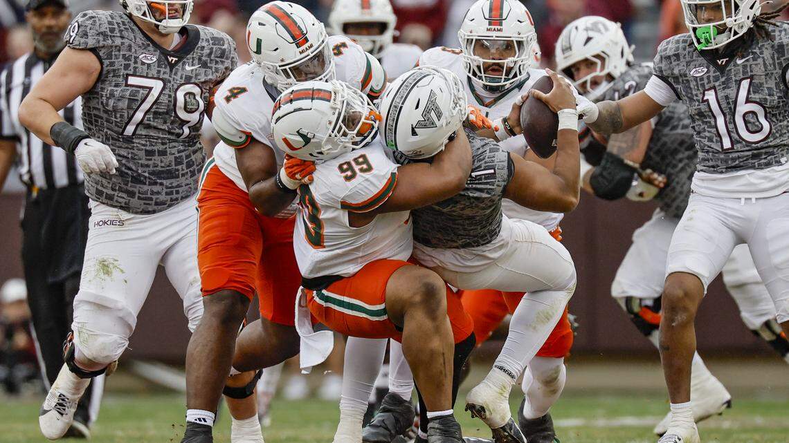 Miami Hurricanes defensive lineman Ahmad Moten (99) sacks Virginia Tech Hokies quarterback Kyron Drones (1) in the second half at Lane Stadium in Blacksburg, Virginia, on Saturday, November 22, 2025.