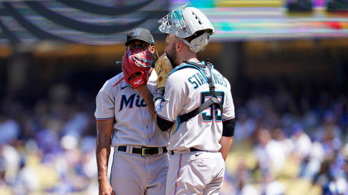 Miami Marlins starting pitcher Sandy Alcantara, left, talks with catcher Jacob Stallings on the mound after giving up a single to Los Angeles Dodgers’ Freddie Freeman during the third inning of a baseball game Sunday, Aug. 21, 2022, in Los Angeles. (AP Photo/Marcio Jose Sanchez)
