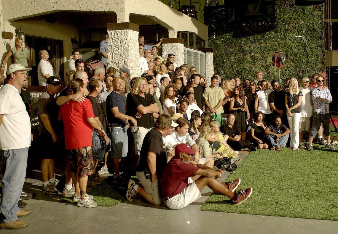 The cast and crew of Burn Notice assembles for a group photo showing just how many people it takes to make a TV show at the Coconut Grove Expo Center.
