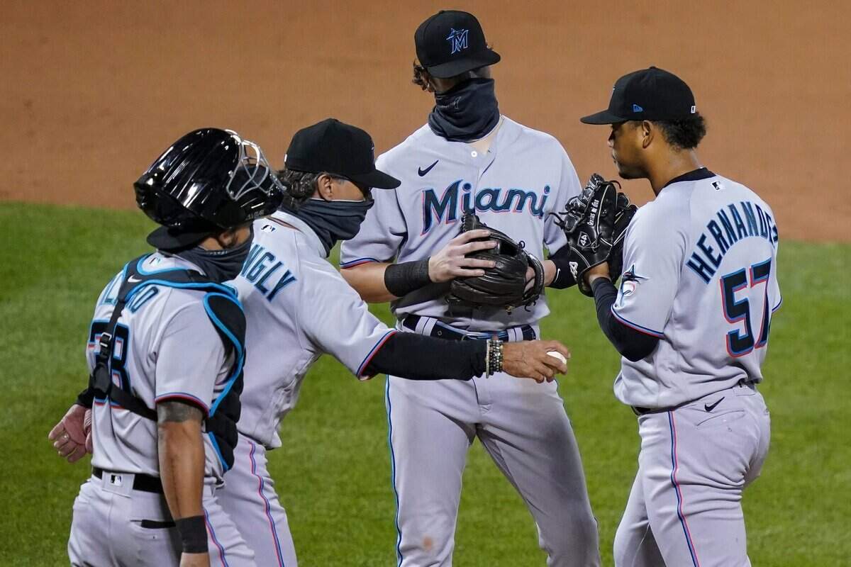 Miami Marlins starting pitcher Elieser Hernandez (57) is relieved by manager Don Mattingly, second from left, in the fifth inning of a baseball game against the New York Mets, Wednesday, Aug. 26, 2020, in New York.