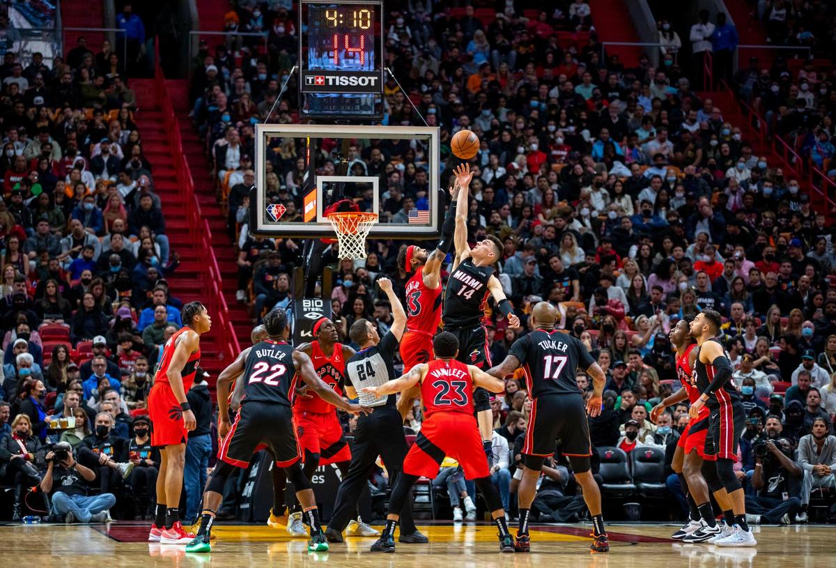 Miami Heat guard Tyler Herro (14) fights for the tip-off with Toronto Raptors Gary Trent Jr. (33) during the second ovetime of an NBA game at FTX Arena in Downtown Miami, Florida, on Saturday, January 29, 2022.