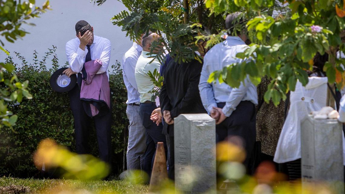 A man pauses as friends and family gather around the grave of Brad Cohen, one of the victims of the Champlain Towers South collapse, who was laid to rest at Mount Sinai Memorial Park Cemetery in Opa-locka on July 19, 2021.