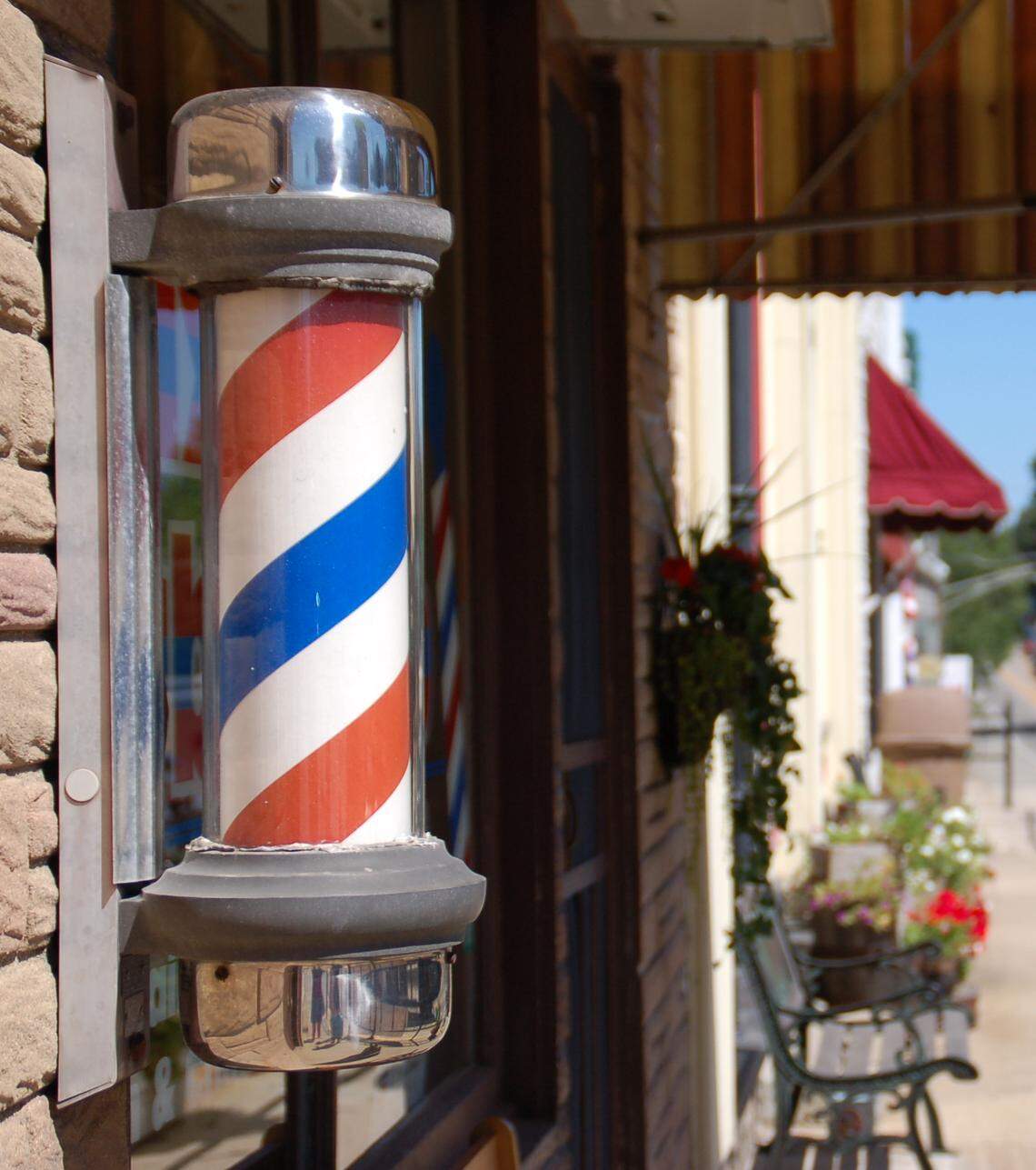 When barber shops and hair salons reopen, they may have to place chairs six feet apart while stylists wear masks and gloves.