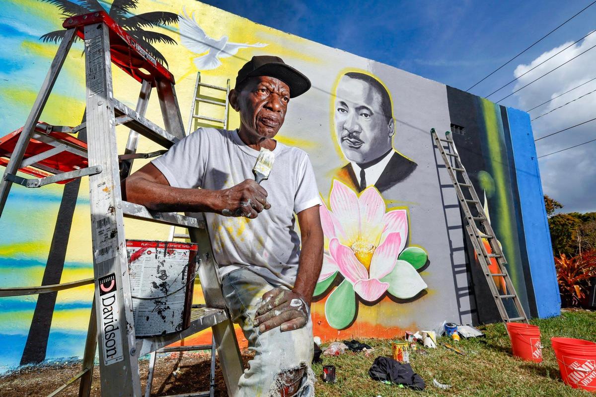 Artist Marvin Weeks stands in front of the mural he is painting of Martin Luther King Jr. on the side of a building near N.W. 18th Avenue and 62nd Street in Liberty City to prepare for the MLK parade. This year, Trump’s inauguration coincides with Martin Luther King Day.