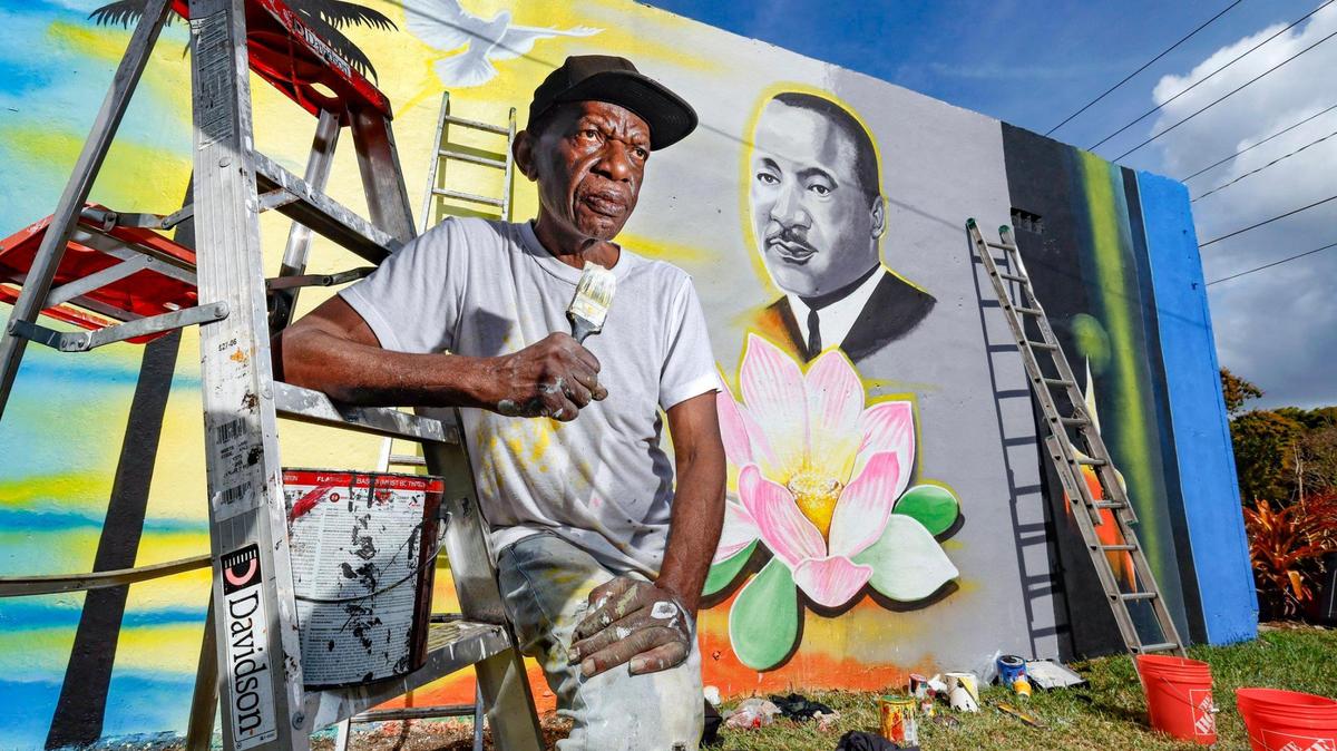 Artist Marvin Weeks stands in front of the mural he is painting of Martin Luther King Jr. on the side of a building near N.W. 18th Avenue and 62nd Street in Liberty City to prepare for the MLK parade. This year, Trump’s inauguration coincides with Martin Luther King Day.