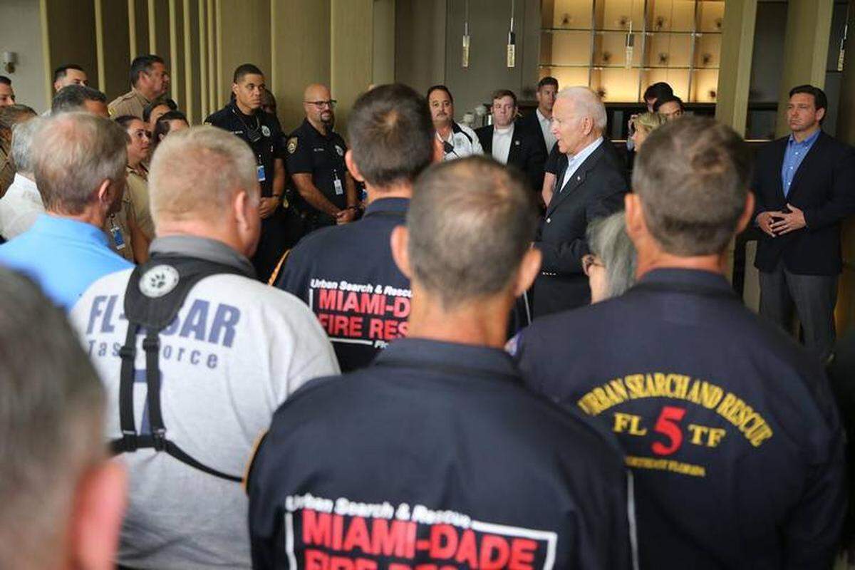 President Biden, center right, acknowledged the hard work and frustrations of first responders working at the scene of the Champlain Towers South collapse.