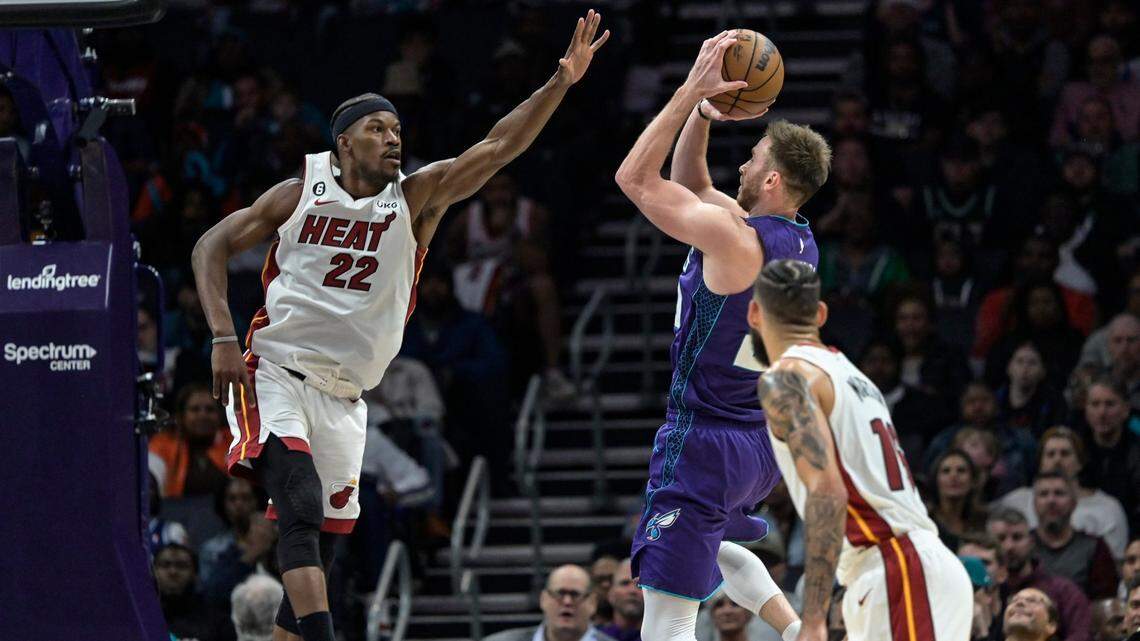 Miami Heat forward Jimmy Butler (22) attempts to block a shot from Charlotte Hornets forward Gordon Hayward during the second half of an NBA basketball game, Saturday, Feb. 25, 2023, in Charlotte, N.C.