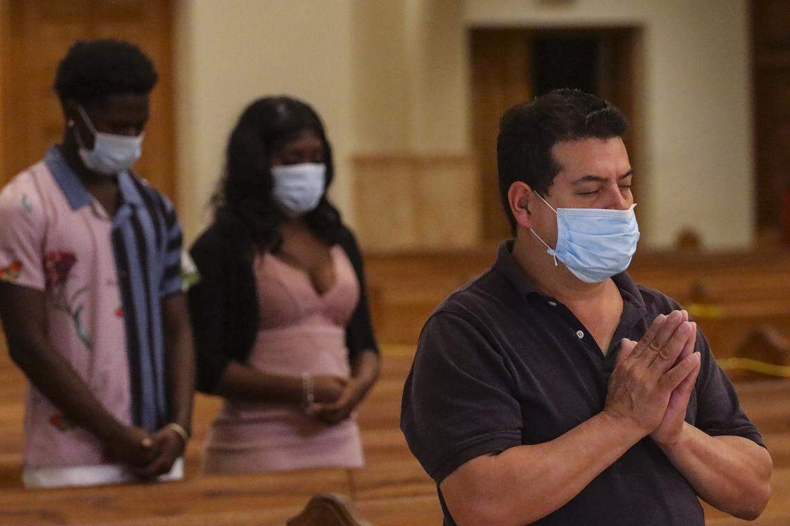 Worshipers attend the 8:15 a.m. English Mass wearing mask and practicing social distancing as the Archdiocese of Miami resumed celebration of Masses on Tuesday, May 26, 2020 at the Cathedral of Saint Mary (St. Mary’s Cathedral) in Miami. The Archdiocese had suspended in-person Masses in mid-March due to COVID-19.