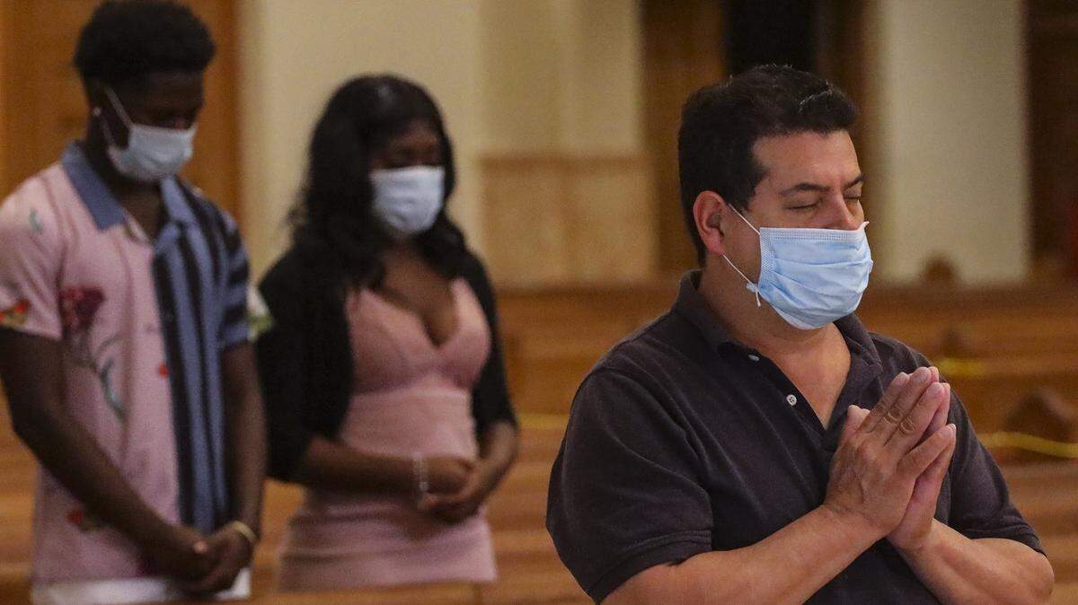 Worshipers attend the 8:15 a.m. English Mass wearing mask and practicing social distancing as the Archdiocese of Miami resumed celebration of Masses on Tuesday, May 26, 2020 at the Cathedral of Saint Mary (St. Mary’s Cathedral) in Miami. The Archdiocese had suspended in-person Masses in mid-March due to COVID-19.