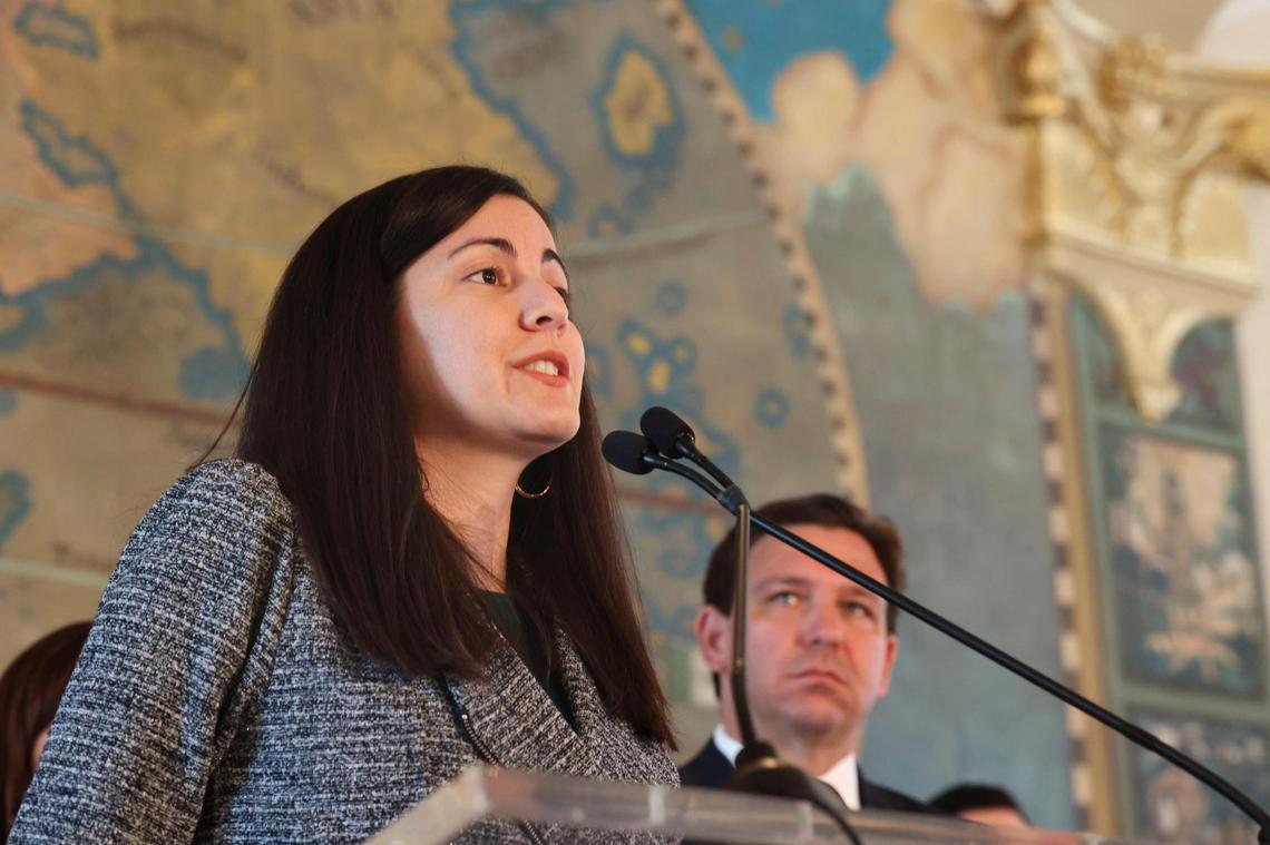 Rosa Maria Paya speaks about her father while Governor Ron DeSantis watches during a Honoring the Victims of Communism press conference at the Freedom Tower in Miami on Monday, May 9, 2022. Paya’s late father, Oswaldo, will have a plaza named after him. DeSantis later sign Senate bill 160 to make this designation.