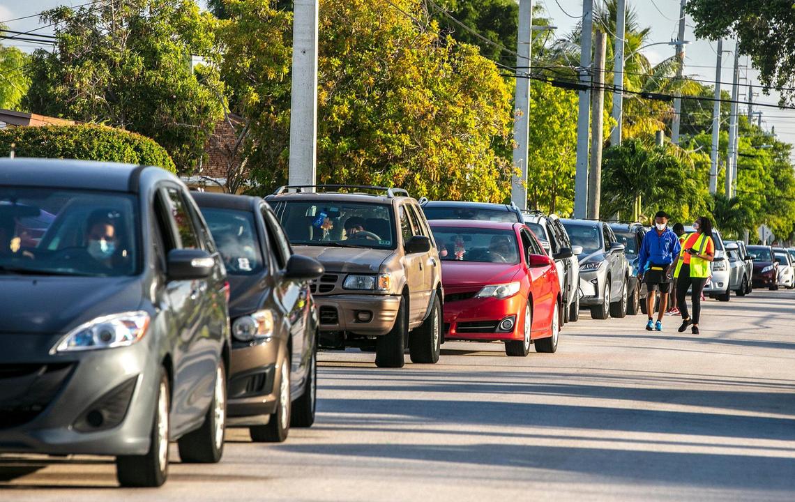North Miami Beach residents lined up in their cars along Northeast Fourth Avenue during a Publix gift card distribution drive-thru at Uleta Park Community Center on Saturday, June 5, 2021.