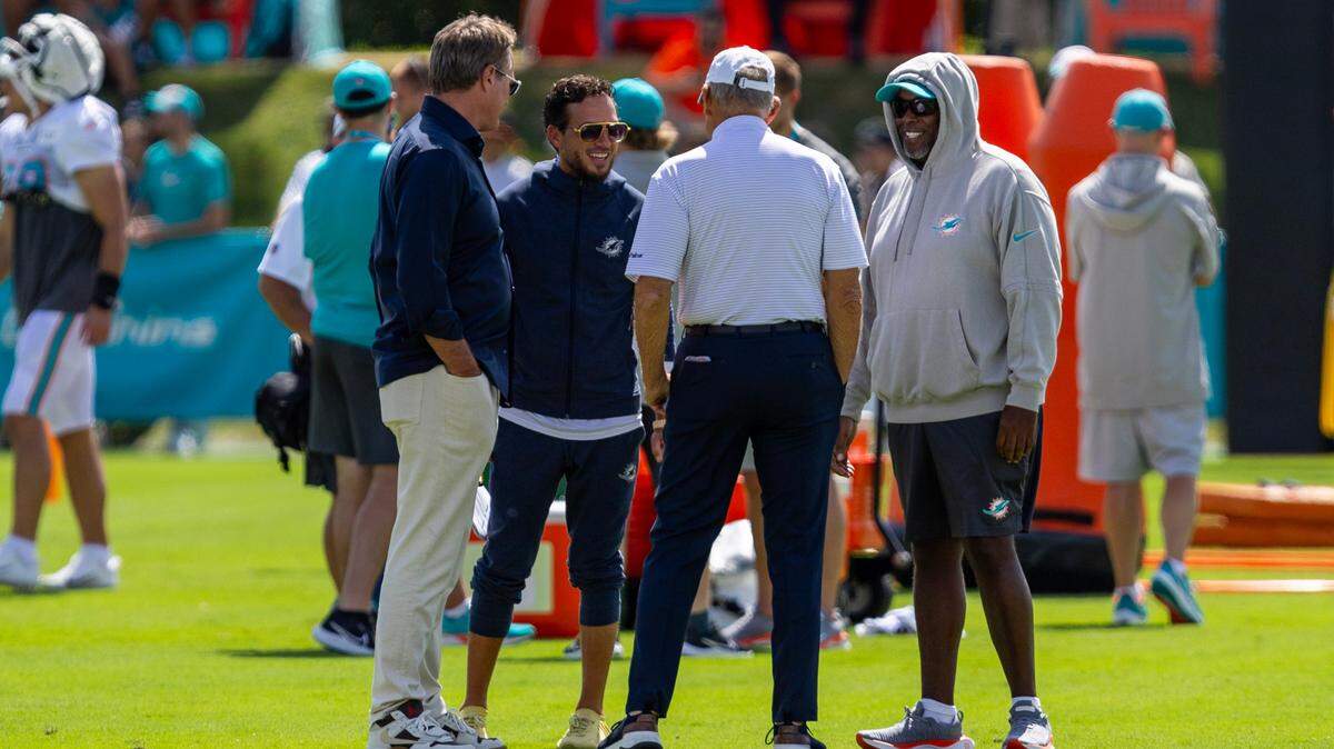 Miami Dolphins owner and chairman Stephen M. Ross, center, speaks with Vice Chairman Tom Garfinkel, far left, and general manager Chris Grier, far right, and head coach Mike McDaniel, second form left, during Day 6 of training camp at Baptist Health Training Complex on Tuesday, July 30, 2024, in Miami Gardens, Fla.