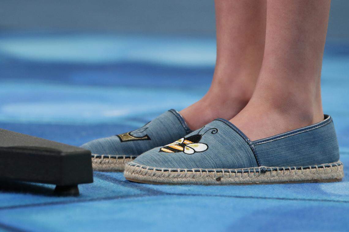 Simone Kaplan, 12, from Davie, Fla., wears shoes with bees on them as she competes in the Scripps National Spelling Bee in Oxon Hill, Md., Thursday, May 31, 2018.