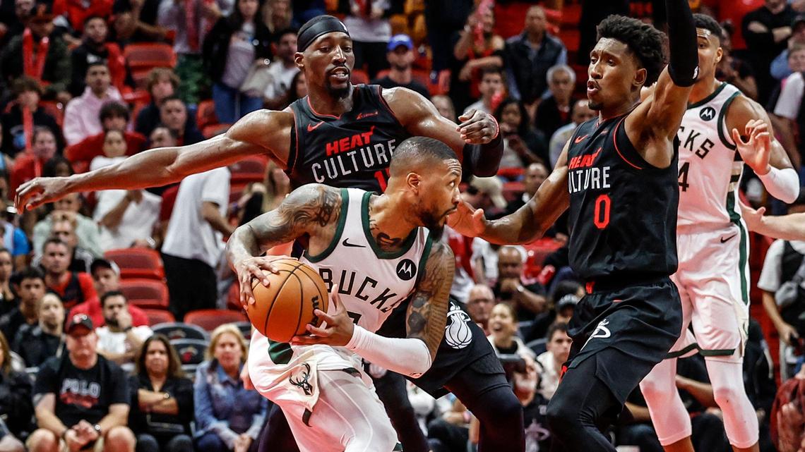 Miami Heat center Bam Adebayo (13) and guard Josh Richardson (0) defend against Milwaukee Bucks guard Damian Lillard (0) in the final minutes of the fourth quarter at the Kaseya Center in Miami on Tuesday, November 28, 2023.