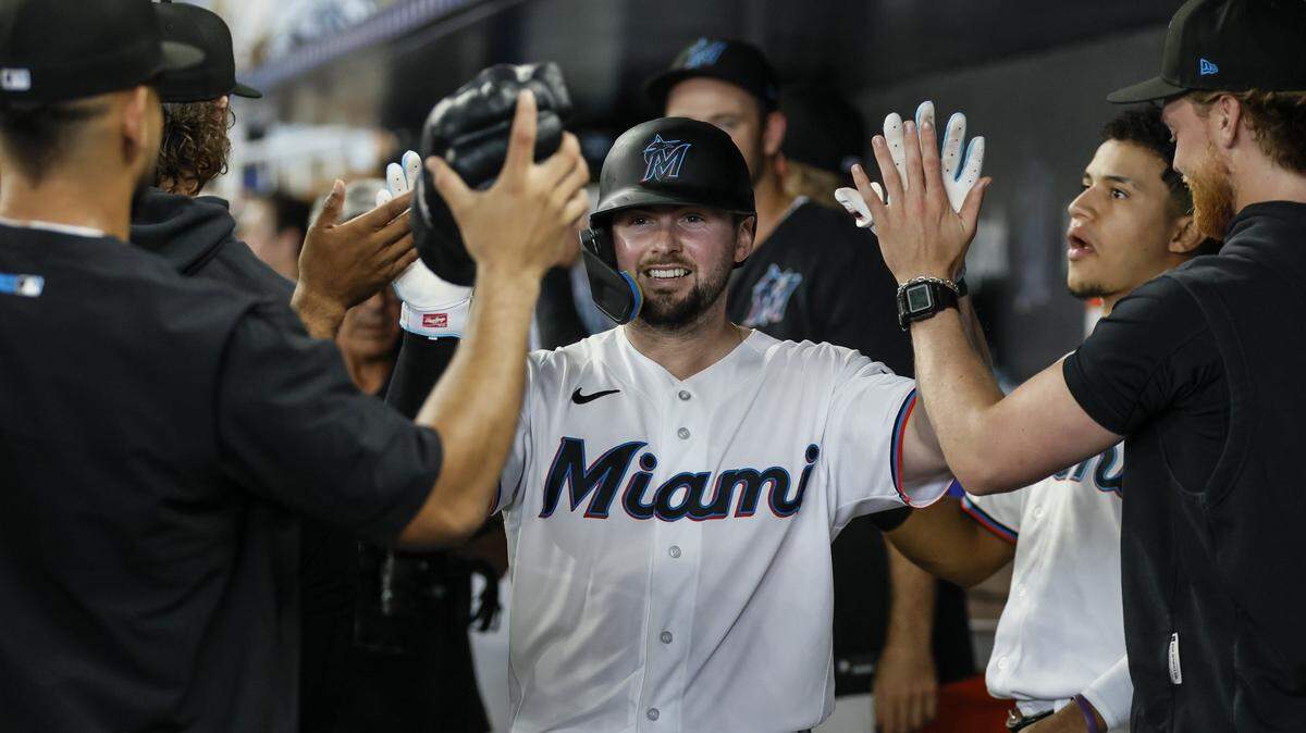 Miami Marlins catcher Liam Hicks (34) celebrates in the dugout after hitting a homerun on a fly ball to right field bringing in Xavier Edwards (9) to score in the second inning against the Chicago White Sox at loanDepot Park in Miami, Florida, on Wednesday, April 1, 2026. 