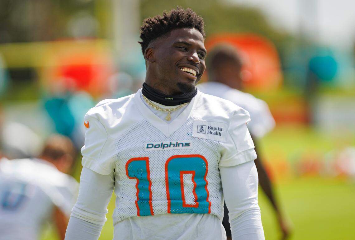 Miami Dolphin’s wide receiver Tyreek Hill (10) smiles at a teammate during Miami Dolphins training camp on Monday, Aug. 12, 2024, at Baptist Training Center at Hard Rock Stadium in Miami Gardens, Fla.