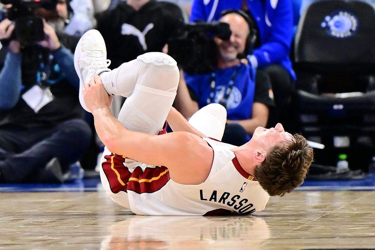 Pelle Larsson #9 of the Miami Heat holds his ankle after an injury in the first half of a Emirates NBA Cup Quarterfinals game against the Orlando Magic at Kia Center on December 09, 2025 in Orlando.