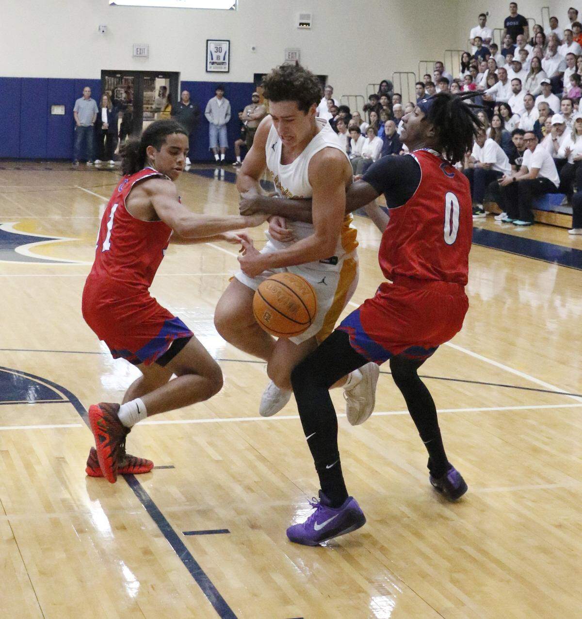 Plantation Colonels try to stop Belen Jesuit Wolverines Lukas Diaz during the Region 4-5A semifinal boys basketball game on Saturday, February 21, 2026 at Belen Jesuit in Miami. Andrew Uloza / for Miami Herald