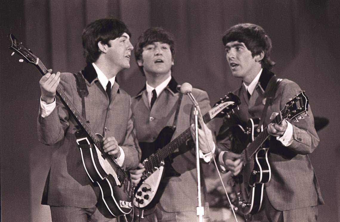 The Beatles, Paul McCartney, John Lennon and George Harrison, perform on the Ed Sullivan Show at the Deauville in 1964.