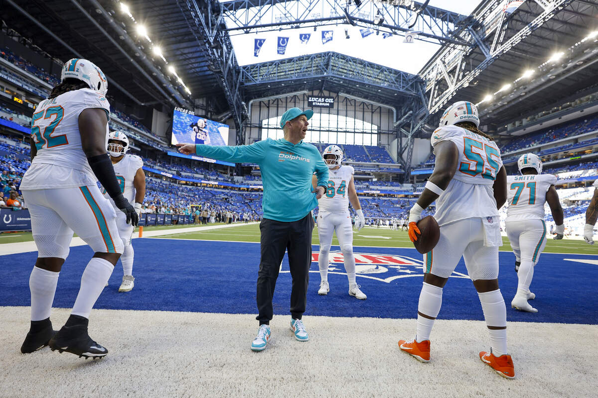 Miami Dolphins offensive line coach Butch Barry works with offensive tackle Patrick Paul (52) and guard Aaron Brewer (55) before a game against the Indianapolis Colts at Lucas Oil Stadium on Sunday, Sept. 7, 2025, in Indianapolis.