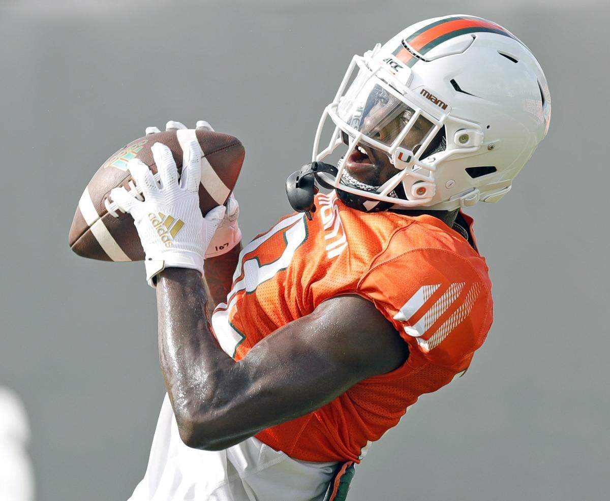 Miami Hurricanes wide receiver Jeremiah Payton (12) catches a pass during practice drills at the University of Miami’s Greentree Field in Coral Gables on Thursday, March 5, 2020.