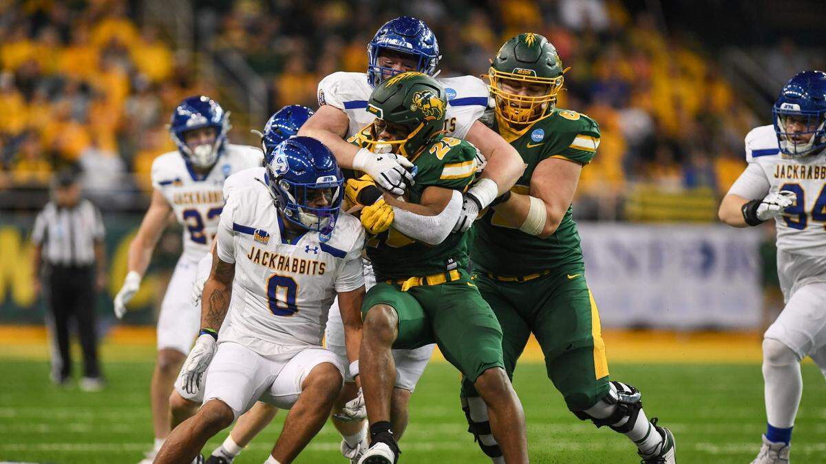 North Dakota State Bison running back CharMar Brown (25) gets tackled by South Dakota State defense on Saturday, Dec. 21, 2024, at Fargodome in Fargo, Nouth Dakota.