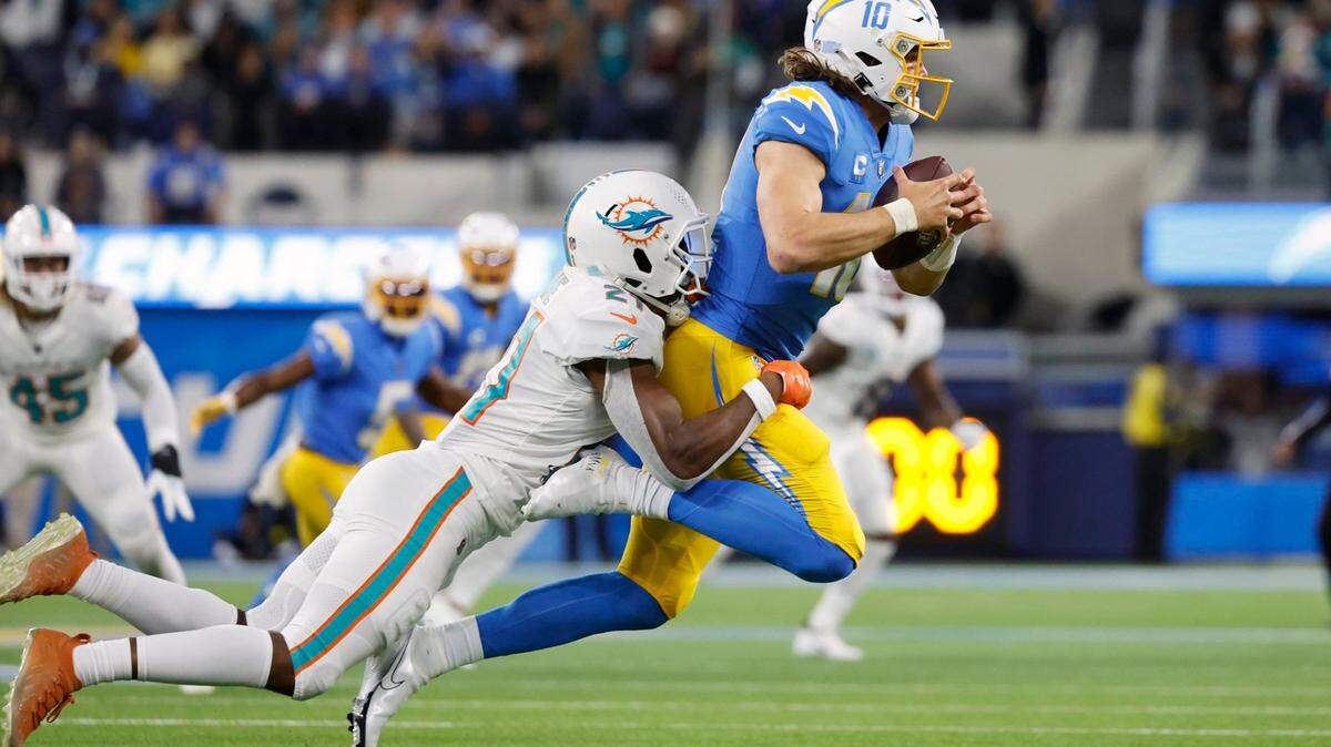 Miami Dolphins safety Eric Rowe (21) sacks Los Angeles Chargers quarterback Justin Herbert (10) in the second quarter at SoFi Stadium in Inglewood, California on Sunday, December 11, 2022.