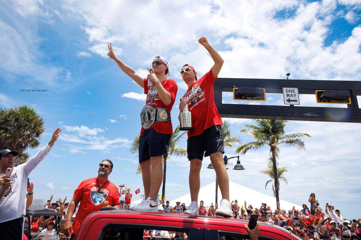 Florida Panthers left wing Matthew Tkachuk (19) and Sam Reinhart (13) wave to fans during the Florida Panthers Stanley Cup Championship victory parade on Sunday, June 22, 2025 down Las Olas in Fort Lauderdale, Fla. 