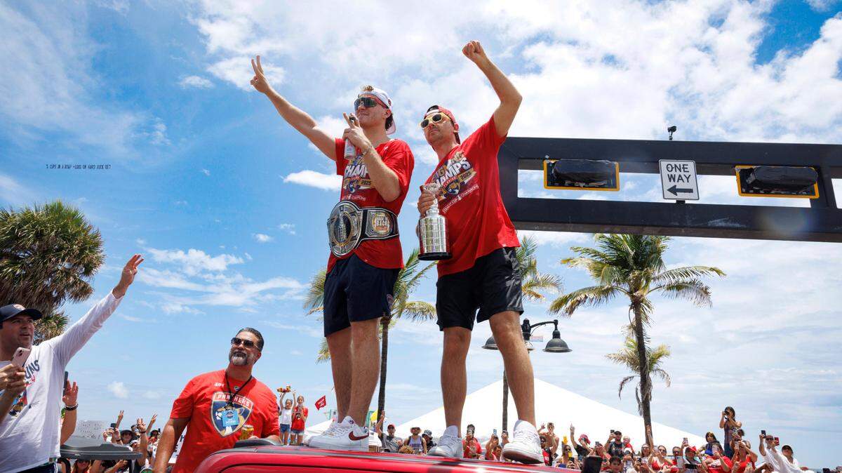 Florida Panthers left wing Matthew Tkachuk (19) and Sam Reinhart (13) wave to fans during the Florida Panthers Stanley Cup Championship victory parade on Sunday, June 22, 2025 down Las Olas in Fort Lauderdale, Fla.