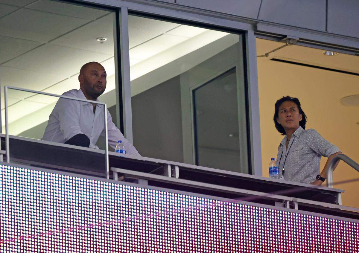 Miami Marlins CEO Derek Jeter and Marlins General Manager Kim Ng look from their suite during the ninth inning of their baseball game against the Atlanta Braves at loanDepot park on Friday, June 11, 2021 in Miami, Florida.