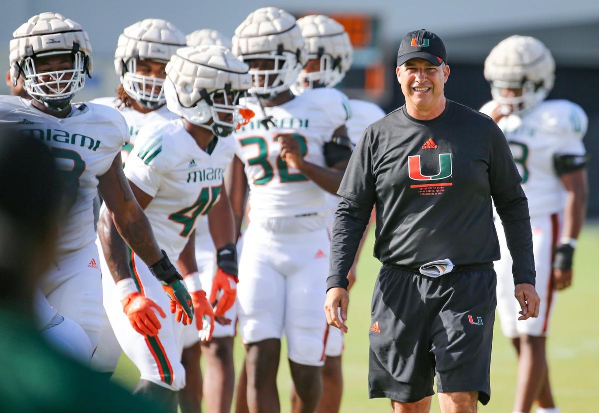 Miami Hurricanes Mario Cristobal watches over his players during practice drills at Greentree Practice Field at the University of Miami in Coral Gables on Thursday, August 11, 2022.