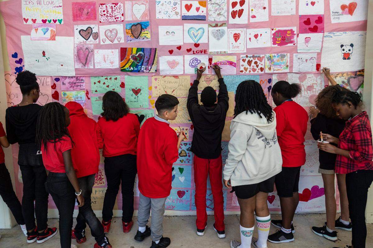 Students at Silver Lakes Middle School in North Lauderdale paint messages of love and friendship on a mural during a ceremony Tuesday, Feb. 14, in memory of those who perished in the shooting at Marjory Stoneman Douglas High School five years ago.