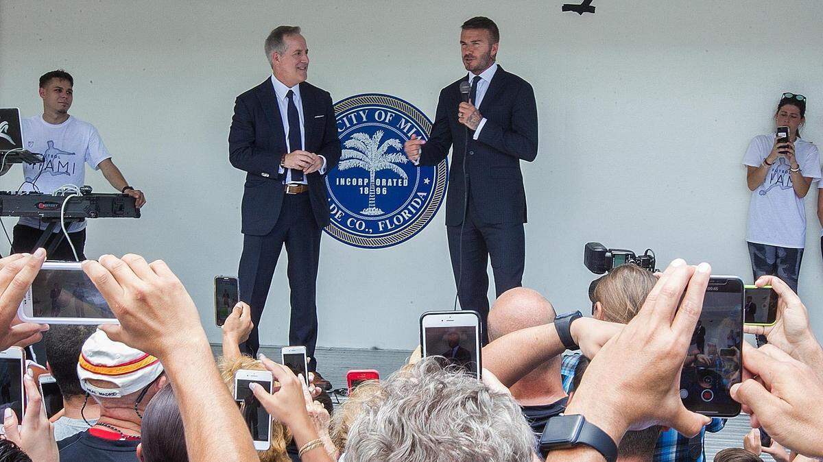 David Beckham speaks at a MLS rally as Jorge Mas, left, listens in before attending City of Miami City Hall to promote MLS on Thursday, July 12, 2018