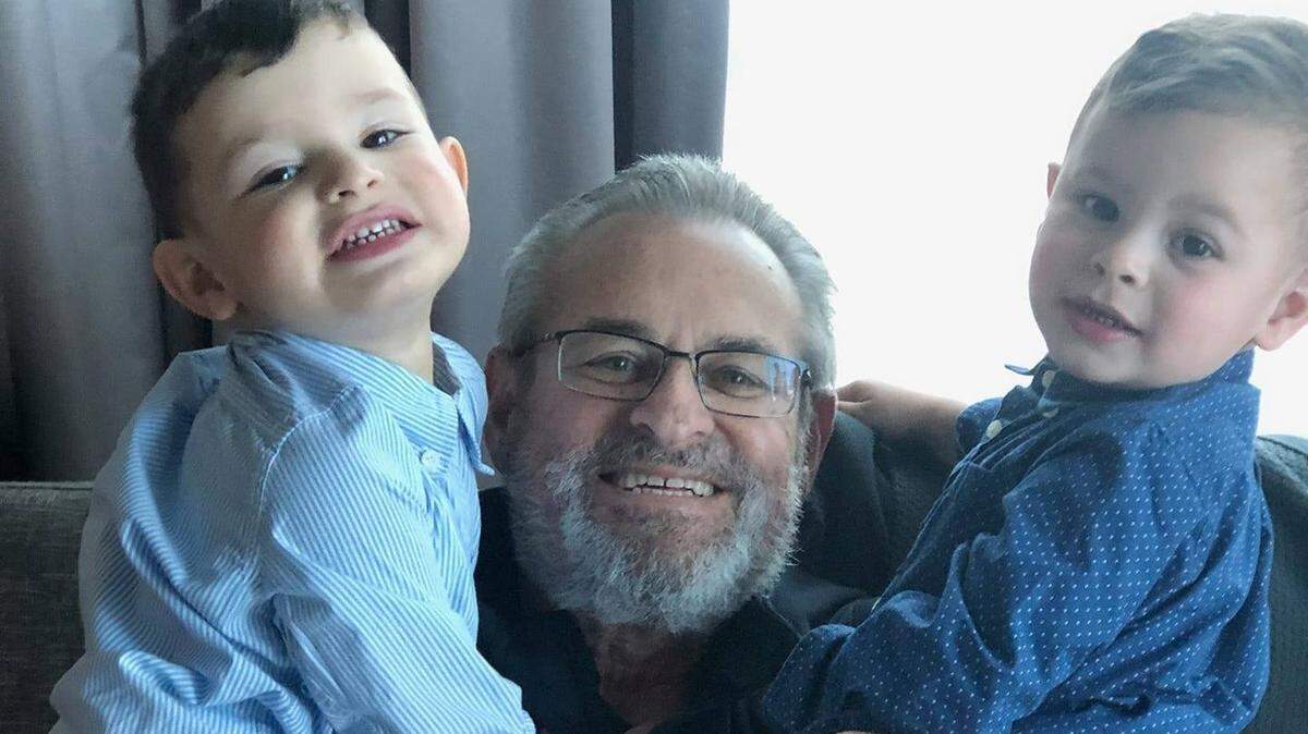 Larry Wahl, longtime spokesman for the Orange Bowl Committee, Miami Hurricanes, New York Yankees and more, is shown holding his two grandsons.