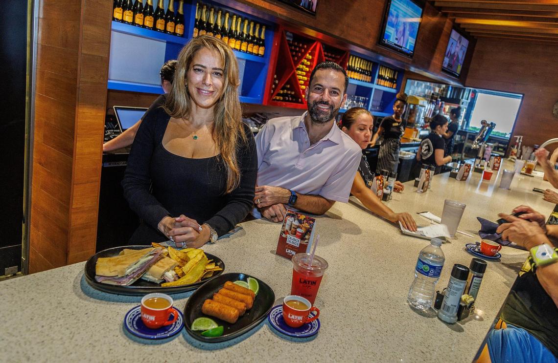 Publicist Mabel De Beunza and Owner-CEO Eric Castellanos display a selection of dishes from the menu at the Latin Cafe 2000 at 875 NW 42nd Ave. in Miami, on Friday September 22, 2023.