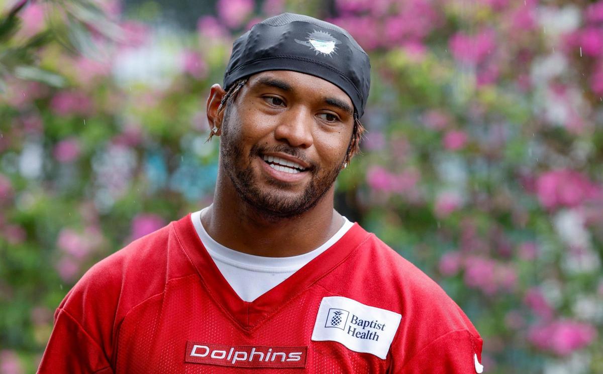 Miami Dolphins quarterback Tua Tagovailoa (1) prepares to speak to reporters after practice at Miami Dolphins Training Camp in Miami Gardens, Florida, on Wednesday, July 23, 2025.
