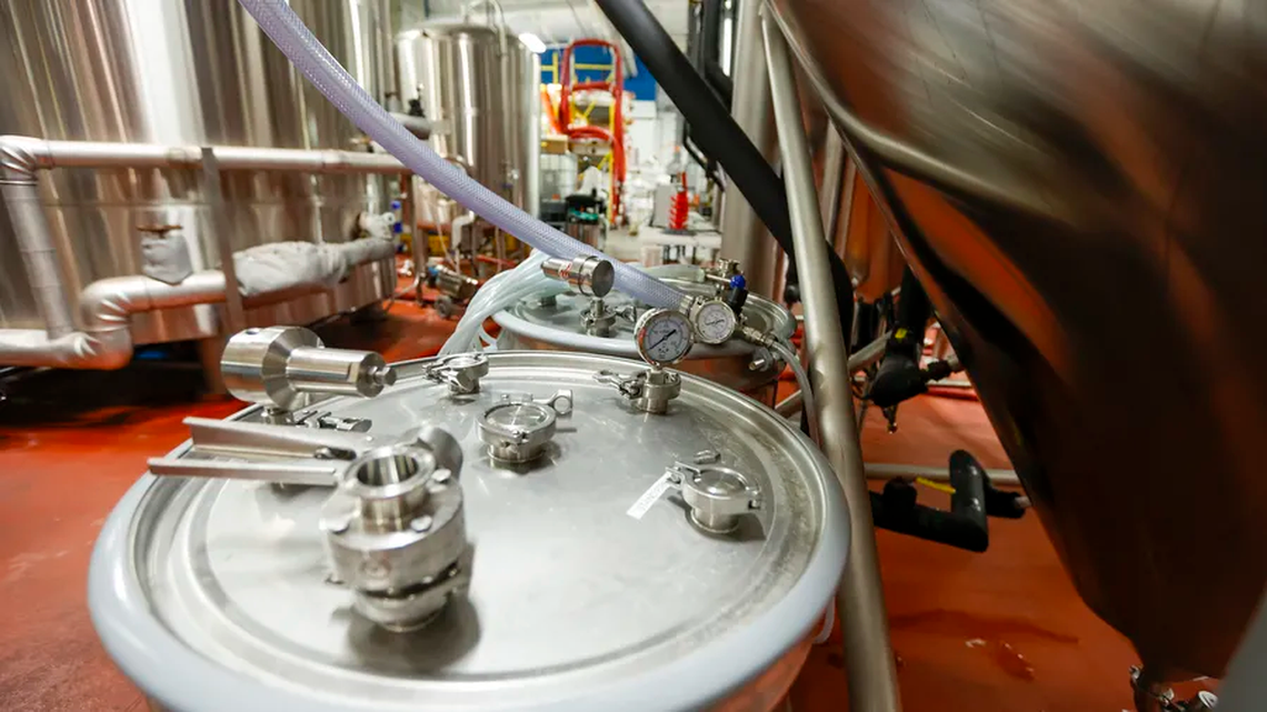 A barrel used to collect carbon dioxide sits near a fermenter at Big Storm Brewing Co. in Clearwater. Big Storm has implemented a system that captures carbon dioxide typically released in the brewing process and purifies it to carbonate and package more beer.