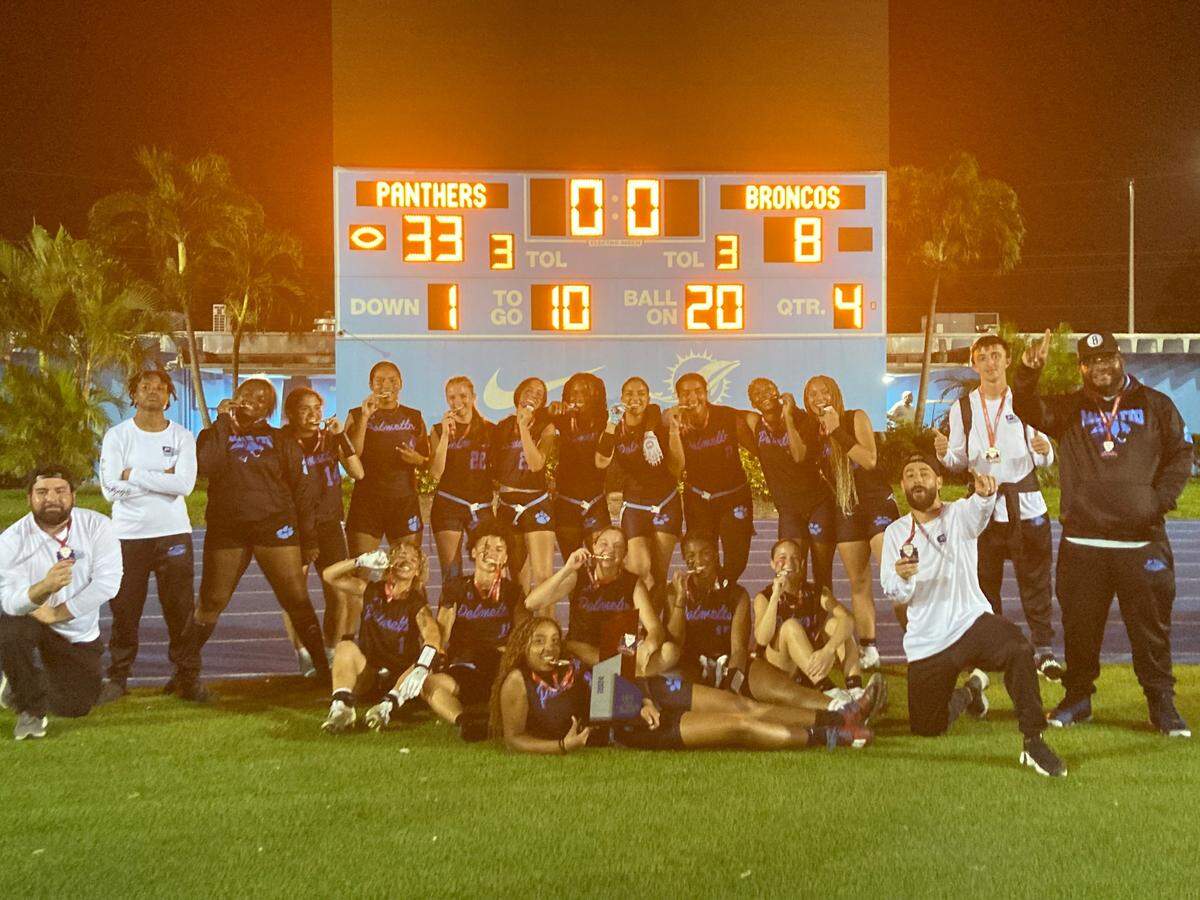 Miami Palmetto players celebrate with their first GMAC flag football championship trophy on Friday night at Traz Powell Stadium in Miami, Fla.