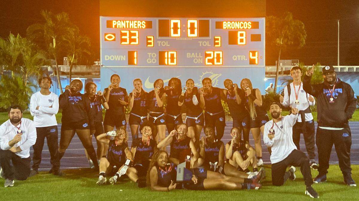 Miami Palmetto players celebrate with their first GMAC flag football championship trophy on Friday night at Traz Powell Stadium in Miami, Fla.