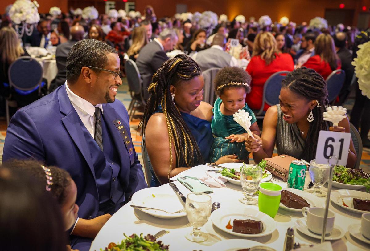 Don Clerveaux, a science and social studies teacher at Phyllis Ruth Miller Elementary, left, sits with his wife Carmen and their daughter Corrine, 1, and Clerveaux’s sister, Vivencia. Clerveaux was named the 2024 Francisco R. Walker Teacher of the Year for Miami-Dade County Public Schools during a ceremony on Tuesday, Jan. 31, 2023.