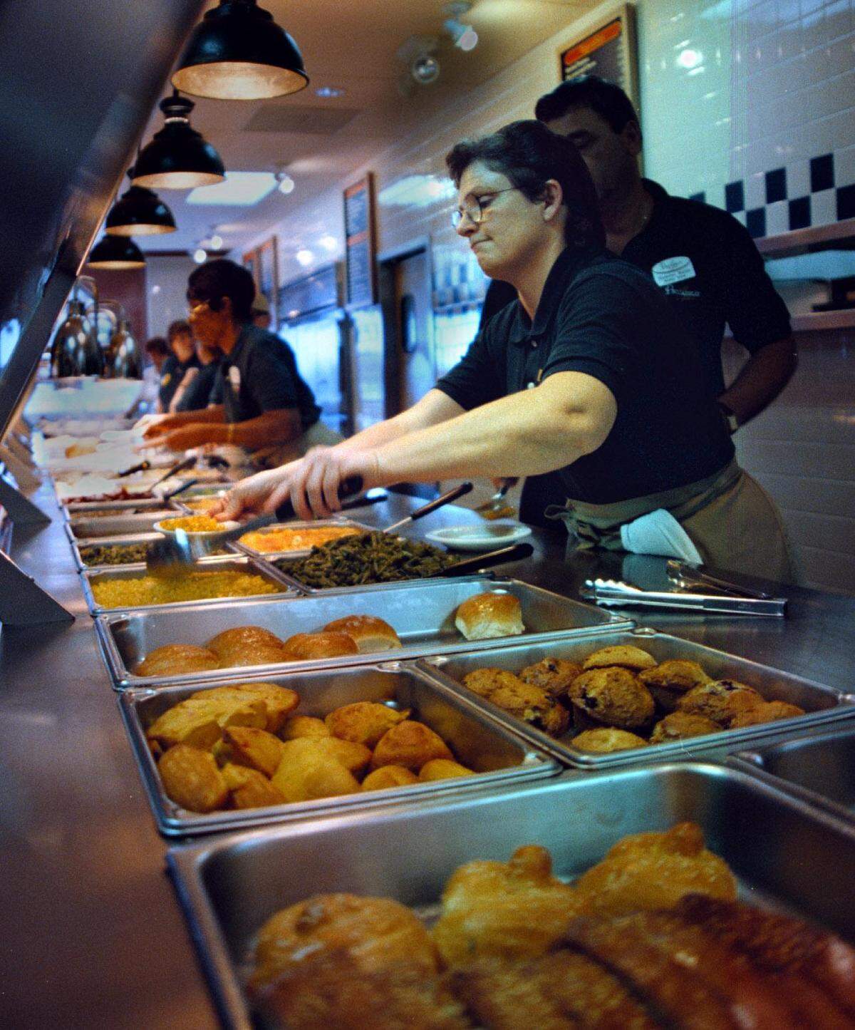 In 1999, server Kim Allen ladles one of 16 side dishes at the grand opening of Piccadilly Cafeteria on University Drive in Davie.
